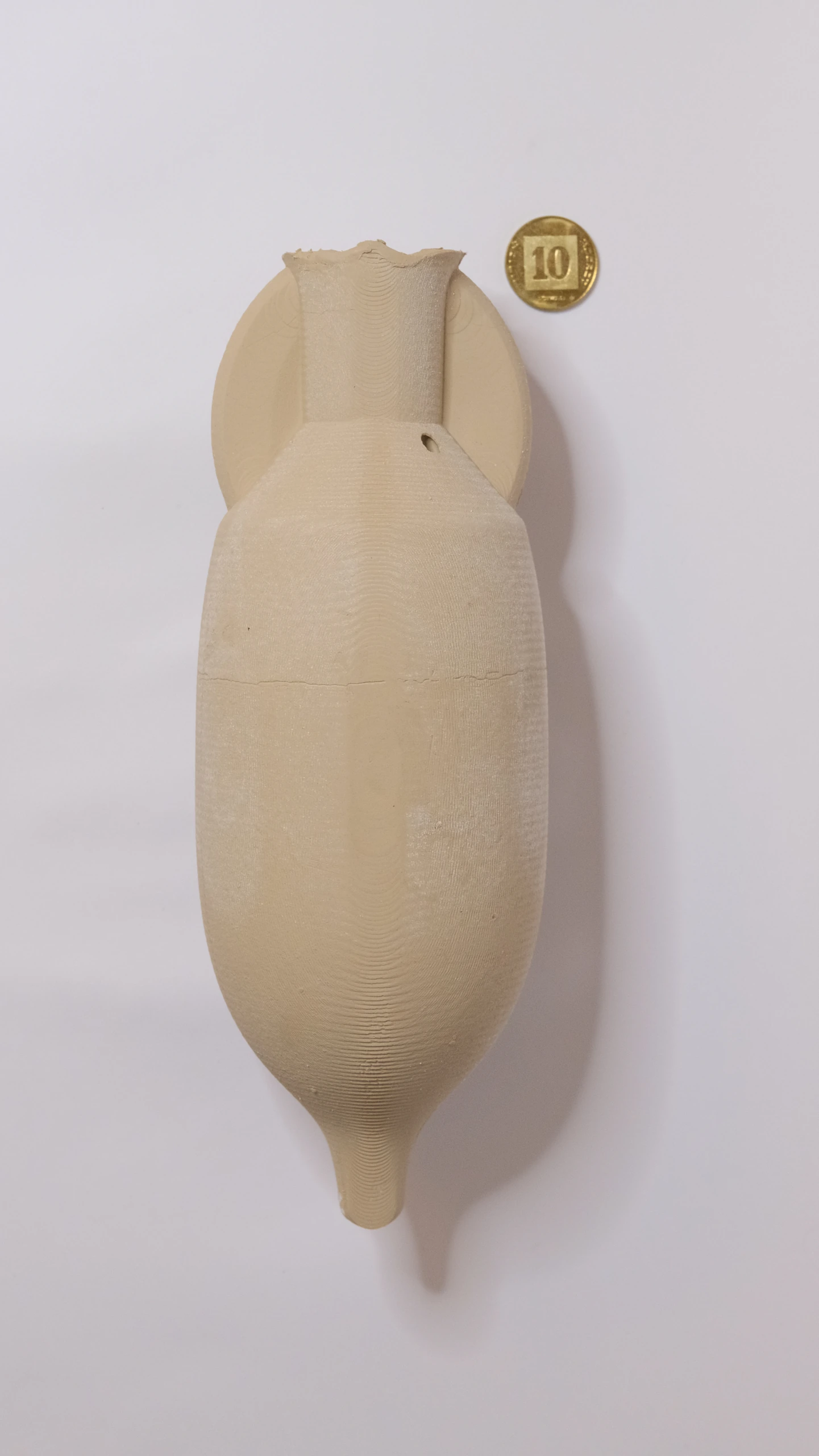 Fine side of the large clay Amphora, showing curved form and close-spaced tool marks