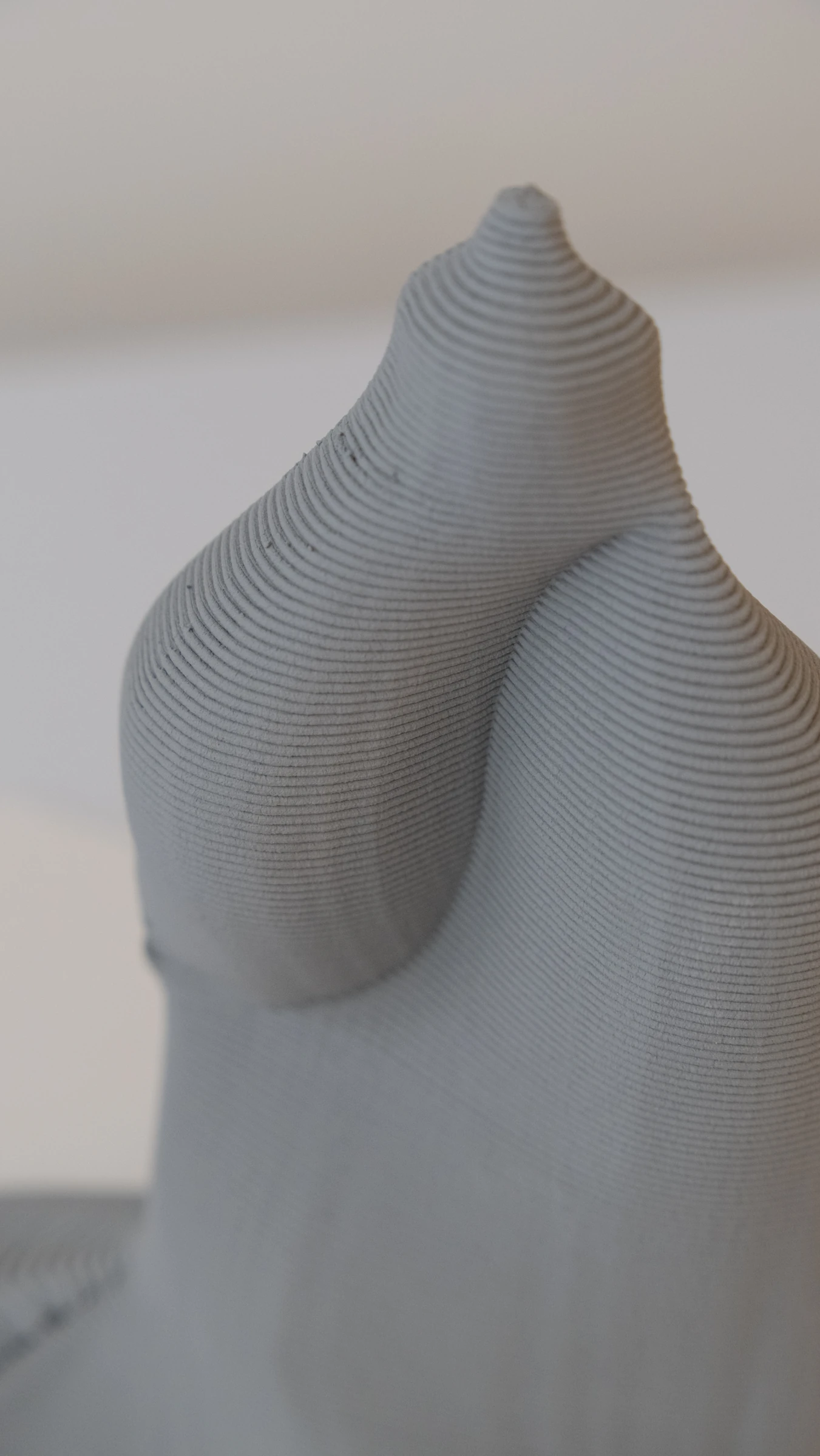 Close detail of a printed ceramic form, showing the contours of deposited clay