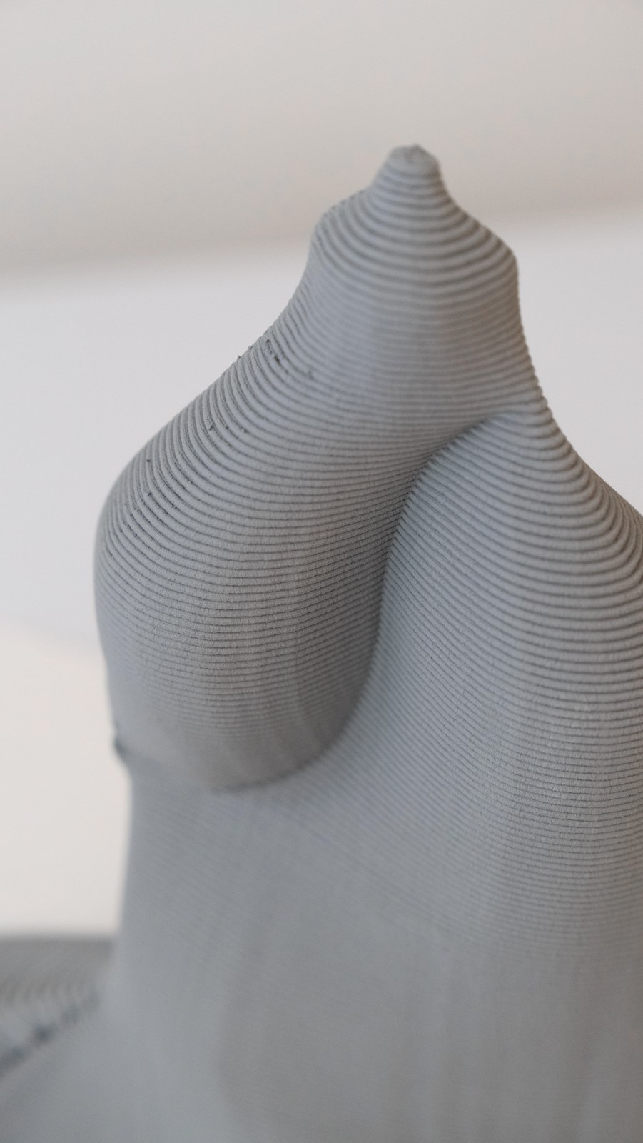 A clay form made with DIRECTED, its surface built from fine printed layers
